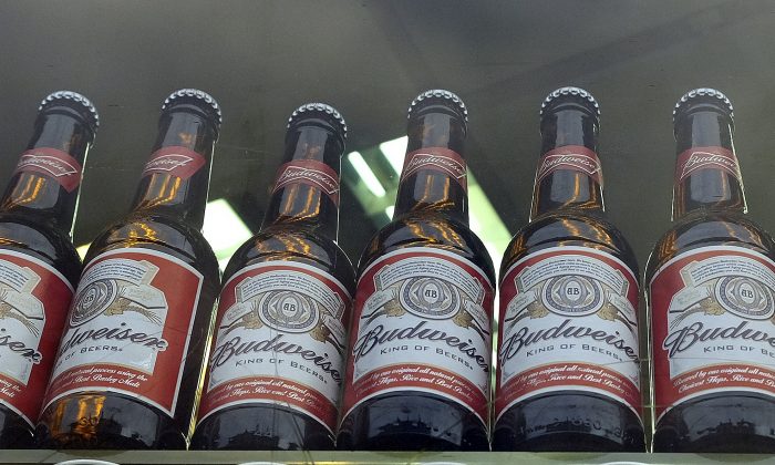 Bottles of Budweiser beer in a shop window in London on Oct. 13, 2015. Budweiser maker Anheuser-Busch InBev on Wednesday Nov. 11, 2015 announced a final agreement to buy SABMiller for 71 billion pounds ($107 billion), in a deal that will combine the world's two biggest brewers and create a company that makes almost a third of the beer consumed worldwide. (AP Photo/Kirsty Wigglesworth)