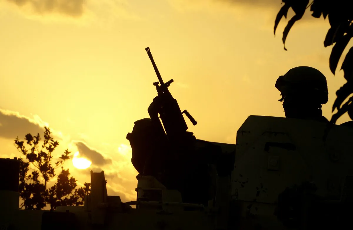 An United Nations Interim Force in Lebanon (UNIFIL) soldier stands guard next to the reported location of the launching of four rockets at Israel, on the outskirts of the southern Lebanese port city of Tyre on Aug. 22, 2013. (Mahmoud Zayyat/AFP/Getty Images)