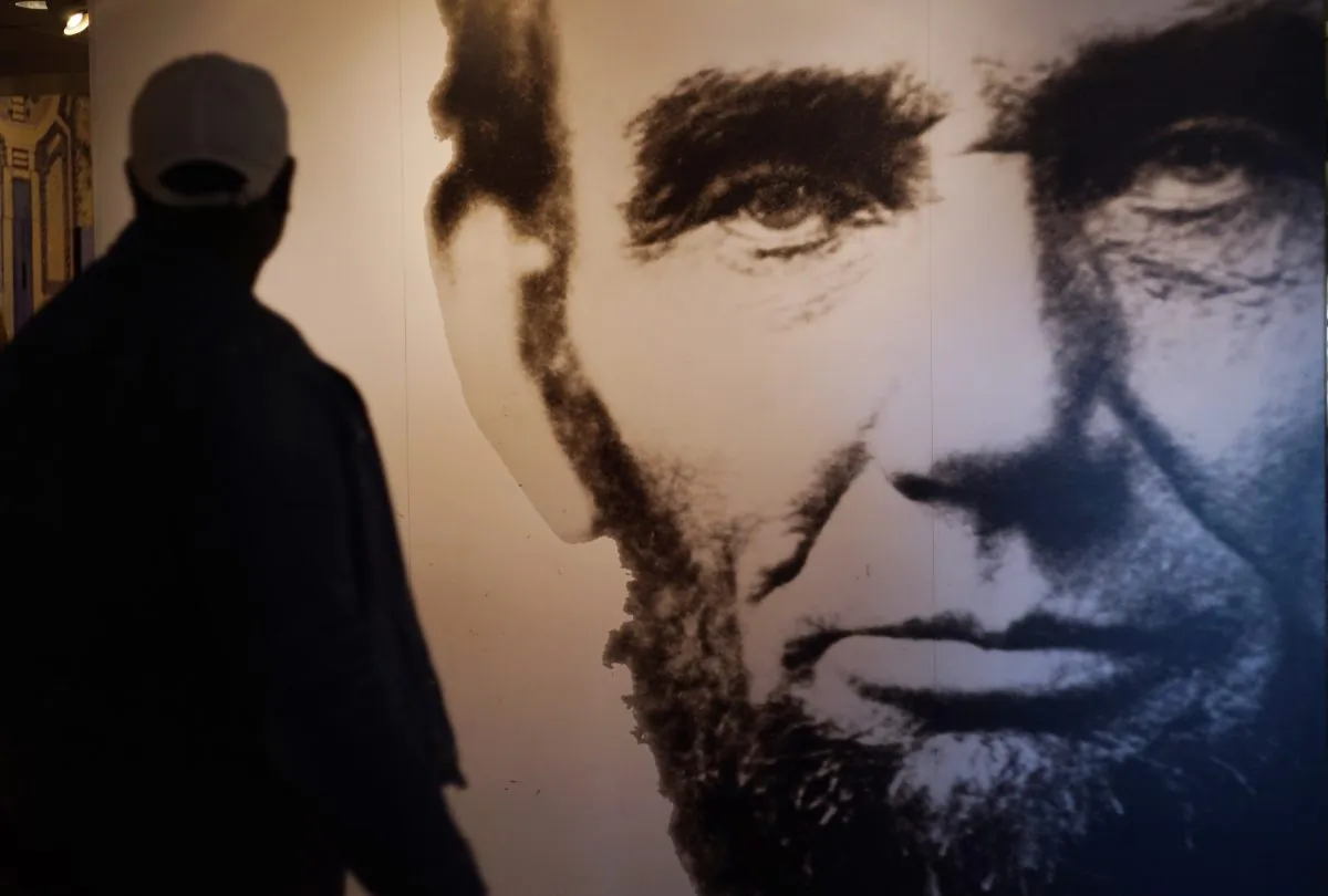 A visitor to an exhibit at the Lincoln Memorial walks past an image of Abraham Lincoln in Washington, D.C., on April 1, 2015. (Mandel Ngan/AFP/Getty Images)