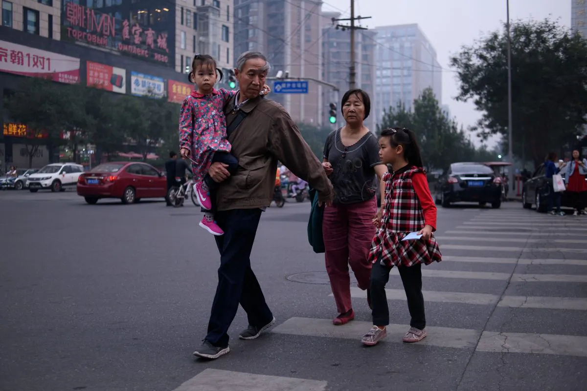 A family in Beijing on Oct. 6, 2015. (Ed Jones/AFP/Getty Images)