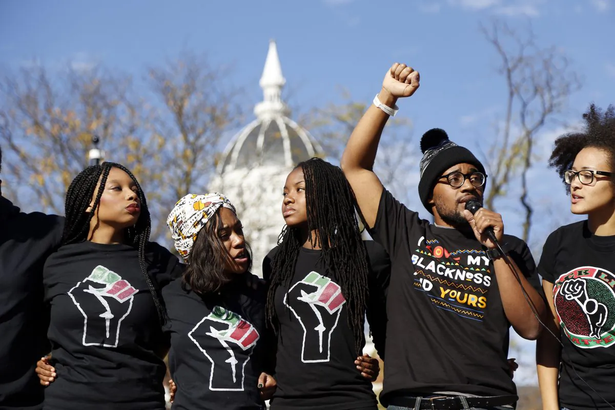 Concerned Student 1950, led by University of Missouri graduate student Jonathan Butler, second from right, speaks following the announcement that University of Missouri System President Tim Wolfe would resign Monday, Nov. 9, 2015, in Columbia, Mo. (Sarah Bell/Missourian via AP)