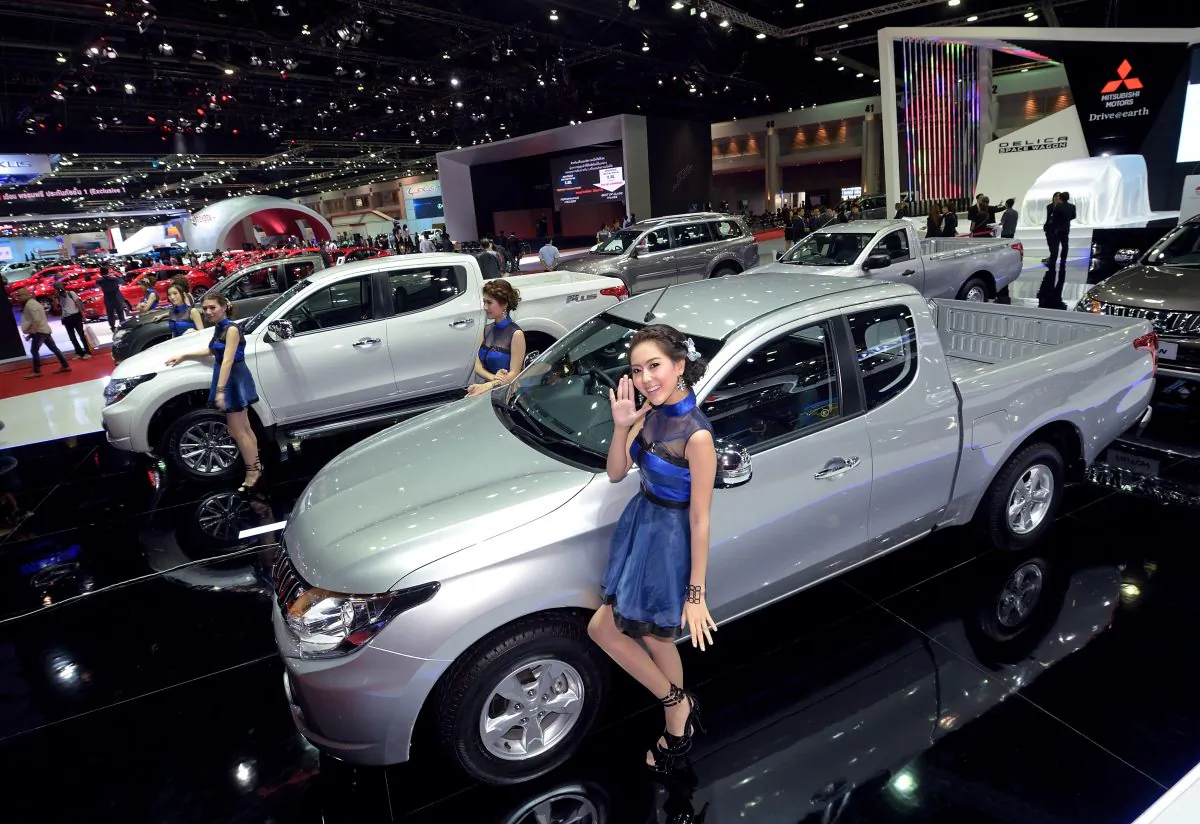 Models pose next to cars displayed at the 36th Bangkok International Motor Show on March 24, 2015. The 36th Bangkok International Motor Show will be held until April 5. AFP PHOTO / PORNCHAI KITTIWONGSAKUL        (Photo credit should read PORNCHAI KITTIWONGSAKUL/AFP/Getty Images)