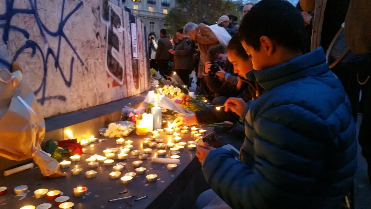 The Monument at the Place de la République in Paris, became a gathering point for people honoring the victims of the deadly terrorist attacks that tore through Paris the previous night, on Nov. 14, 2015. (David Vives/Epoch Times)