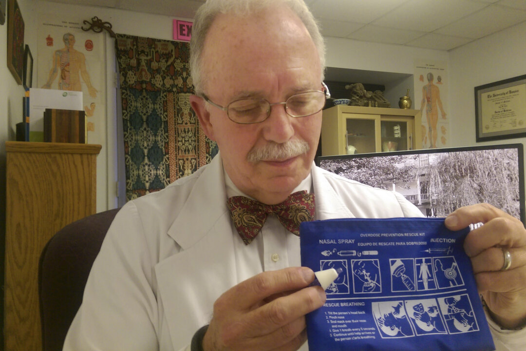 Dr. John Aldis holds a noloxone nasal spray kit with the instruction sheet in Martinsburg, W.Va., on Nov. 3, 2015. Aldis trains people so that they can administer noloxone to an individual who’s having a heroin overdose. (Jenni Vincent/The Journal via AP)