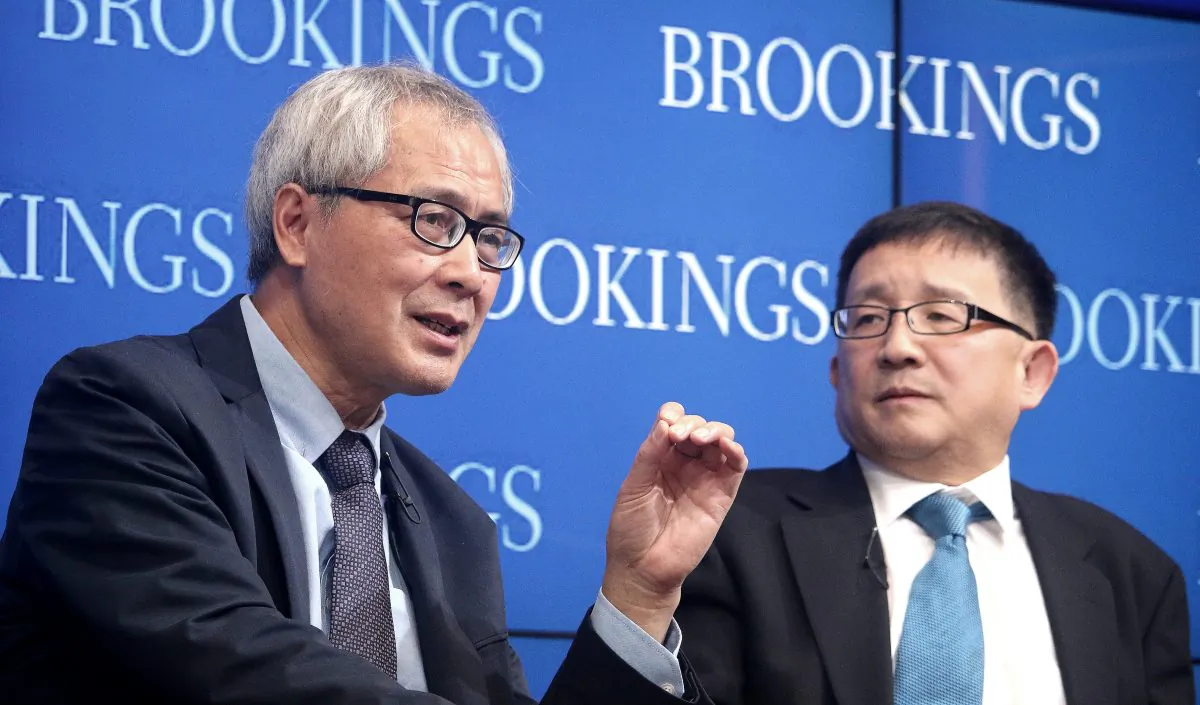 He Huaihong (L), professor of philosophy at Peking University in Beijing, and Cheng Li, director, John L. Thornton China Center, The Brookings Institution, discuss moral decay and ethical awakening in China, at Brookings on Nov. 6. (Gary Feuerberg/Epoch Times)