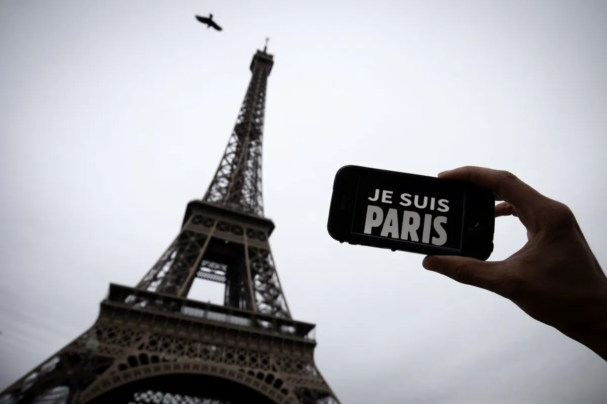 In this illustration picture taken in Paris on November 14, 2015 a person holds aloft a smartphone bearing the message "Je Suis Paris" in front of the Eiffel Tour, following a series of attacks on the city in which at least 128 people were killed. Islamic State jihadists on Saturday claimed a series of coordinated attacks by gunmen and suicide bombers in Paris that killed at least 128 people in scenes of carnage at a concert hall, restaurants and the national stadium.
AFP PHOTO / JOEL SAGET (Photo credit should read JOEL SAGET/AFP/Getty Images)