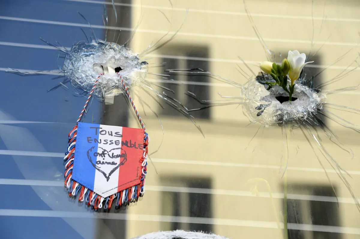 Mourners gathered at a makeshift memorial on Sunday, Nov. 15, 2015, outside of La Belle Equipe bar on rue de Charonne, following a series of coordinated terrorists attacks in Paris, France, on Nov. 13. (Bertrand Guay/AFP/Getty Images)