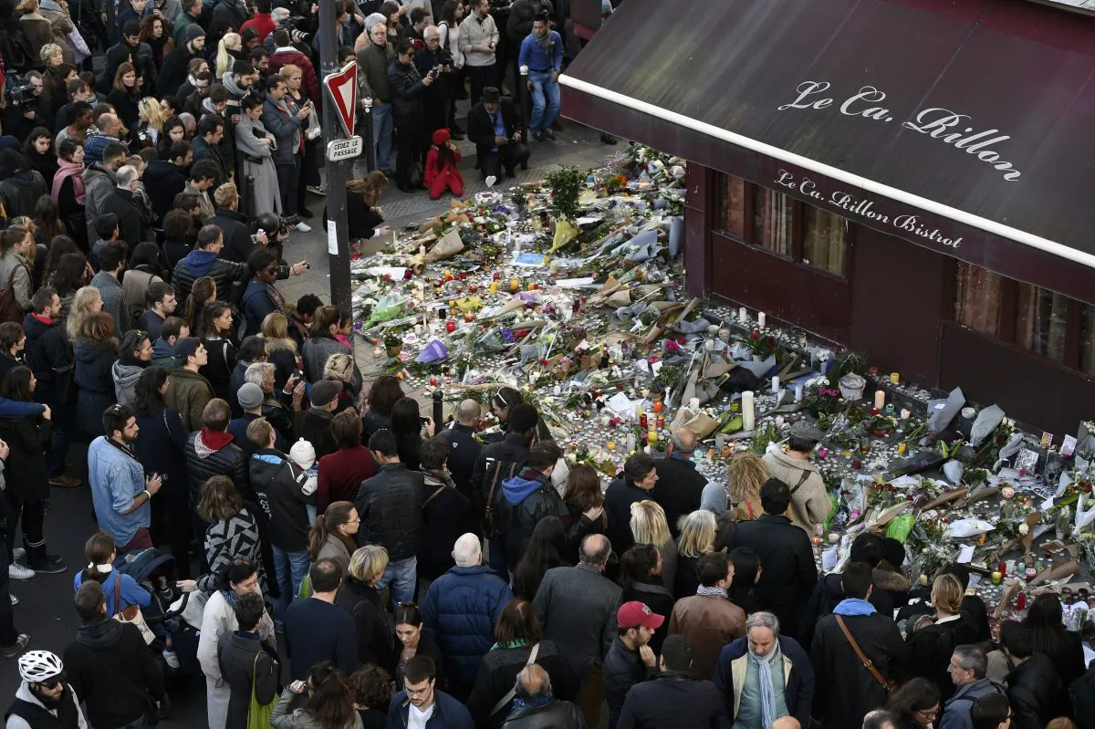 People gather at a makeshift memorial in front of "Le carillon" restaurant on Nov. 16, in the 10th district of Paris, following a series of coordinated terrorists attacks on Nov. 13. (Alain Jocard/AFP/Getty Images)