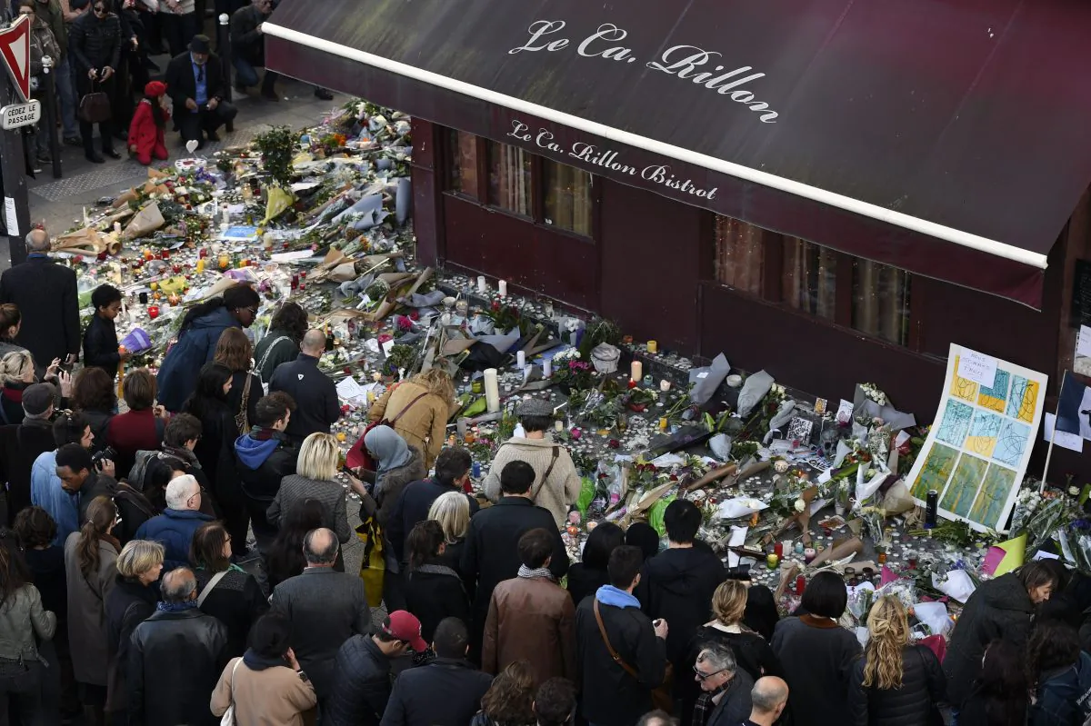 People gather at a makeshift memorial in front of "Le carillon" restaurant on Nov. 16, 2015, in the 10th district of Paris, following a series of coordinated terrorists attacks on Nov. 13. (Alain Jocard/AFP/Getty Images)
