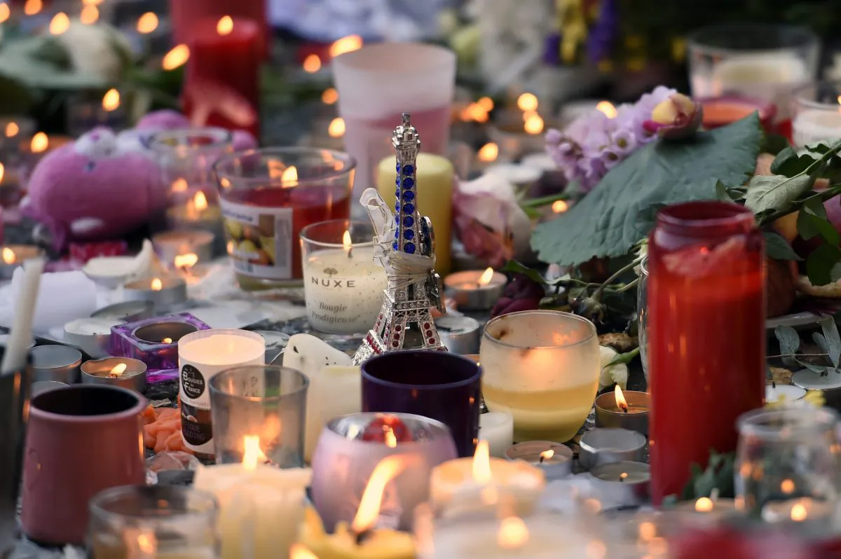 Flowers, candles and a toy Eiffel Tower are pictured at a makeshift memorial near the Bataclan concert hall in Paris on Nov. 15, 2015, two days after a series of deadly attacks. (Miguel Medina/AFP/Getty Images)