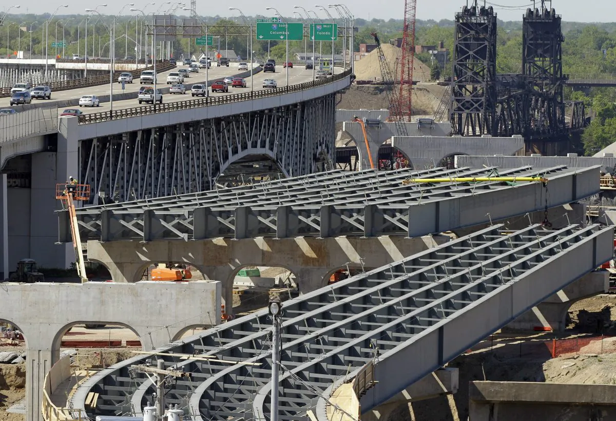 The steel skeleton for the eastern end of the new Innerbelt Bridge in Cleveland sits next to the existing span on May 17, 2012. As Congress races to renew the law that pays for national transportation programs, lobbyists are in a frenzy to shape dozens of provisions, from the length of trucks allowed on roads to whether recalled used cars must be repaired before sold and how to pay for bridges and highways. The bill is the lobbyists’ best shot in years to achieve favorable transportation policies or block regulations they don’t like. Congress hopes to reconcile differences between the House and Senate versions of the bill, and get a compromise to President Barack Obama for his signature before the government’s authority to process highway and transit aid payments to states expires. (AP Photo/Mark Duncan)