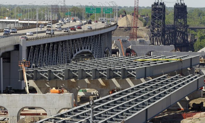 The steel skeleton for the eastern end of the new Innerbelt Bridge in Cleveland sits next to the existing span on May 17, 2012. As Congress races to renew the law that pays for national transportation programs, lobbyists are in a frenzy to shape dozens of provisions, from the length of trucks allowed on roads to whether recalled used cars must be repaired before sold and how to pay for bridges and highways. The bill is the lobbyists’ best shot in years to achieve favorable transportation policies or block regulations they don’t like. Congress hopes to reconcile differences between the House and Senate versions of the bill, and get a compromise to President Barack Obama for his signature before the government’s authority to process highway and transit aid payments to states expires. (AP Photo/Mark Duncan)