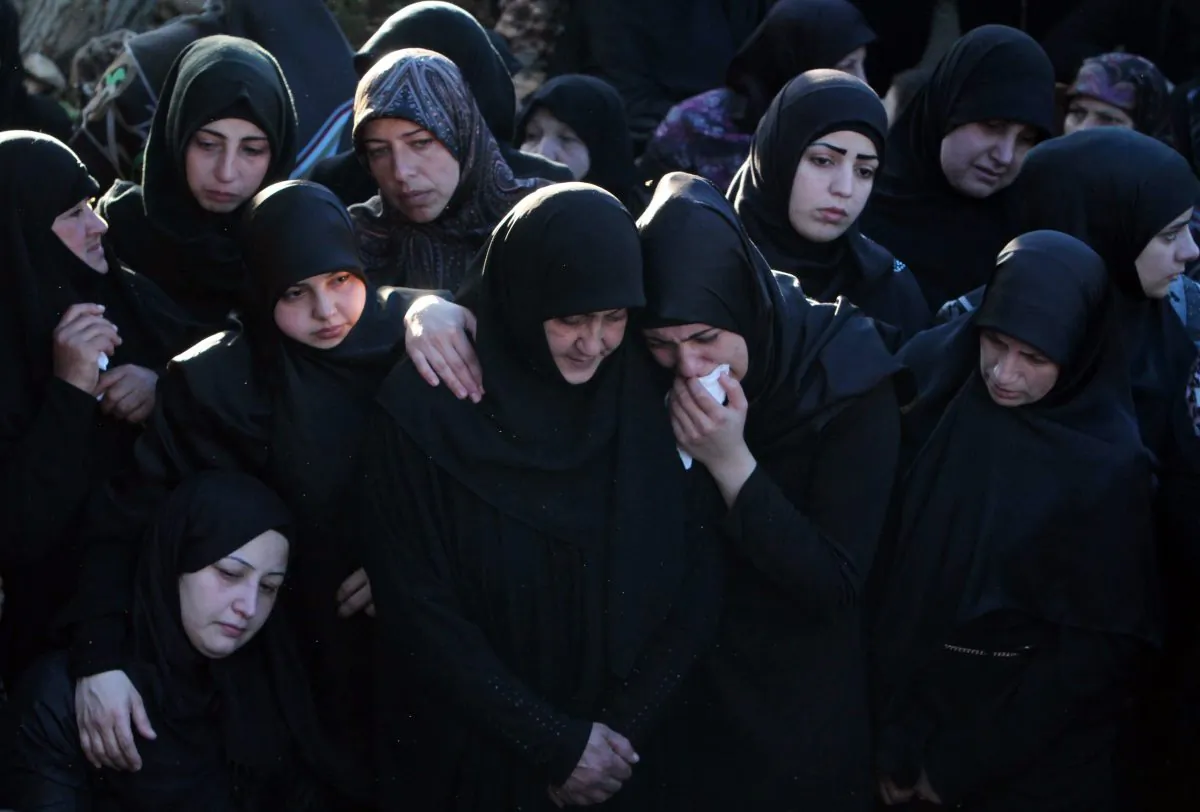 Relatives and friends of Hezbollah member Adel Termos, who was killed in Thursday's twin suicide bombings, mourn during his funeral procession in the southern Lebanese village of Tallousa, Lebanon, on Nov. 13, 2015. (AP Photo/Mohammed Zaatari)