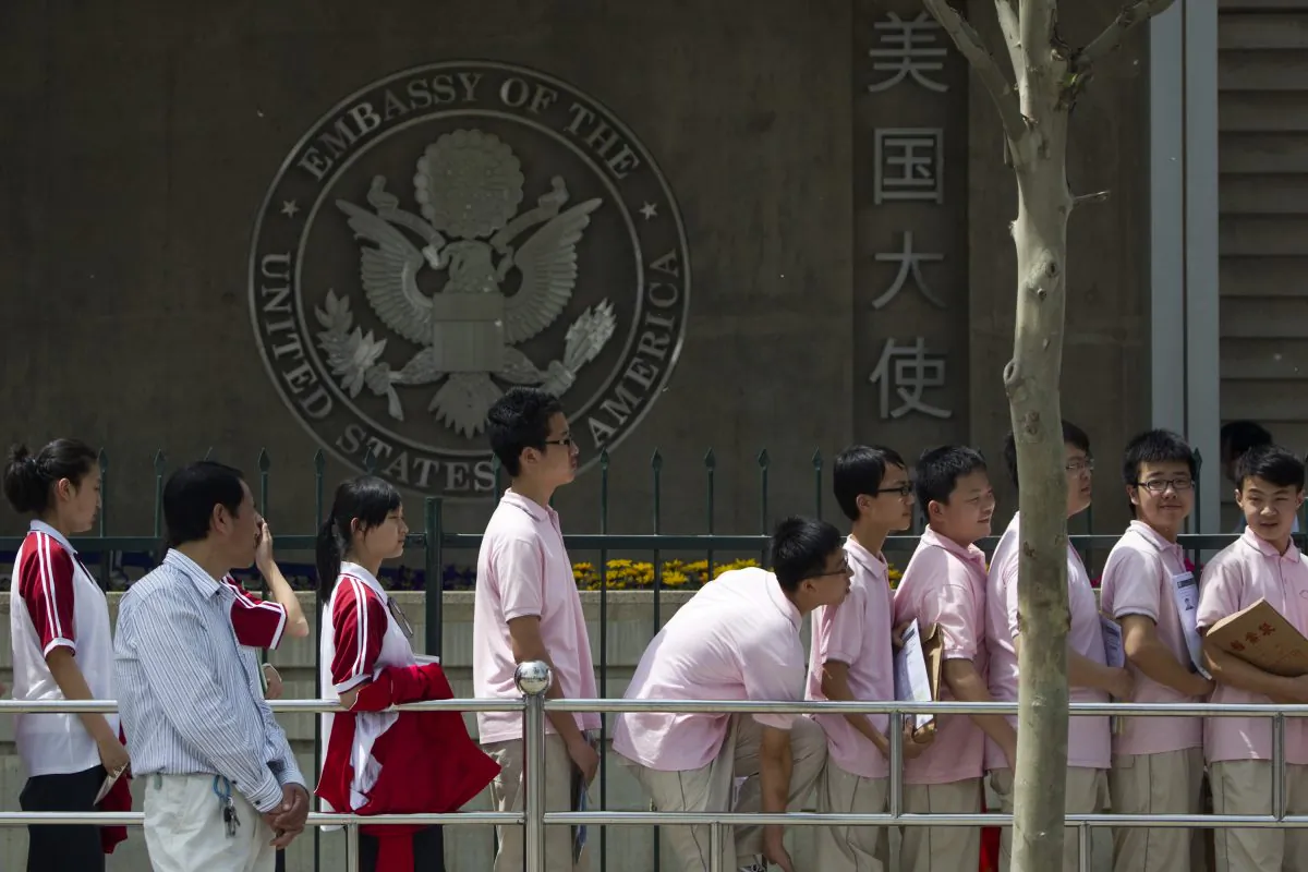 Chinese students wait outside the U.S. Embassy for their visa application interviews in Beijing, China. (Alexander F. Yuan/AP Photo)