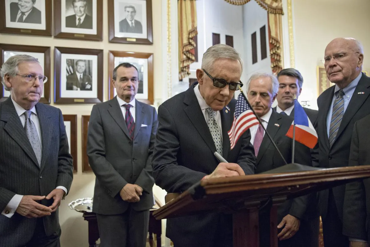French Ambassador to the U.S. Gerard Araud (2L) meets with Senate leaders on Capitol Hill in Washington, D.C., on Nov. 17, 2015, where they signed a book of condolences in remembrance of the victims of the terror attacks in Paris last weekend. (L-R) Senate Majority Leader Mitch McConnell of Ky., Amb. Araud, Senate Minority Leader Harry Reid of Nev., Senate Foreign Relations Committee Chairman Sen. Bob Corker (R-Tenn.), Sen. Cory Gardner (R-Colo.), and Sen. Patrick Leahy (D-Vt.). (AP Photo/J. Scott Applewhite)