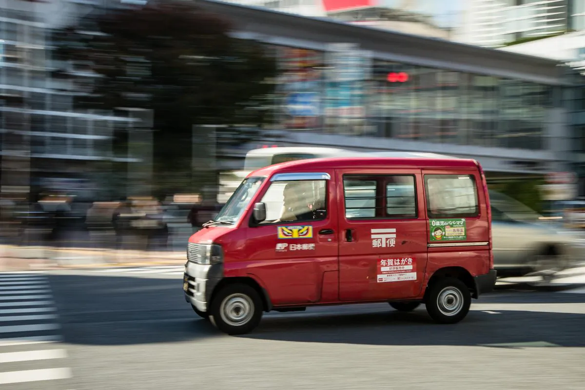 A Japan Post delivery van is seen driving along a road in downtown Tokyo, Japan, on Nov. 4, 2015. (Christopher Jue/Getty Images)