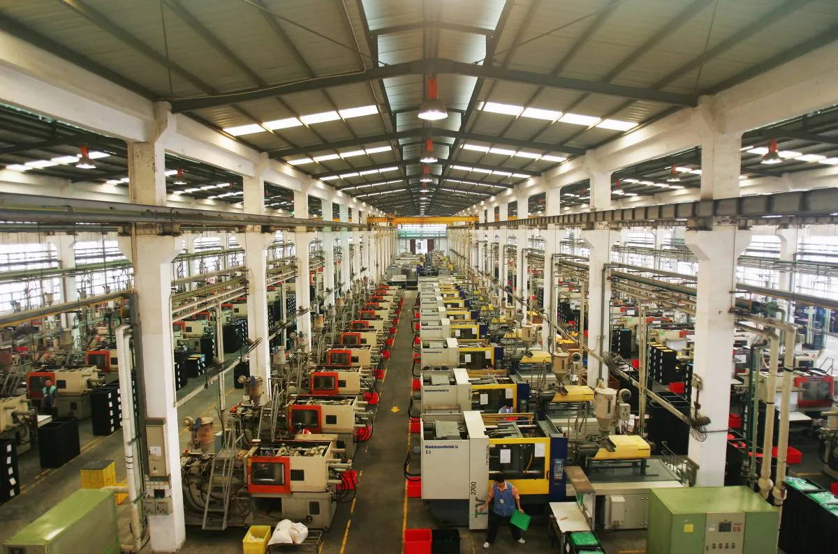 Workers make plastic toy template at the production line of Dongguan Da Lang Wealthwise Plastic Factory in Dongguan, Guangdong Province, China, on Sept. 4, 2007. (Feng Li/Getty Images)