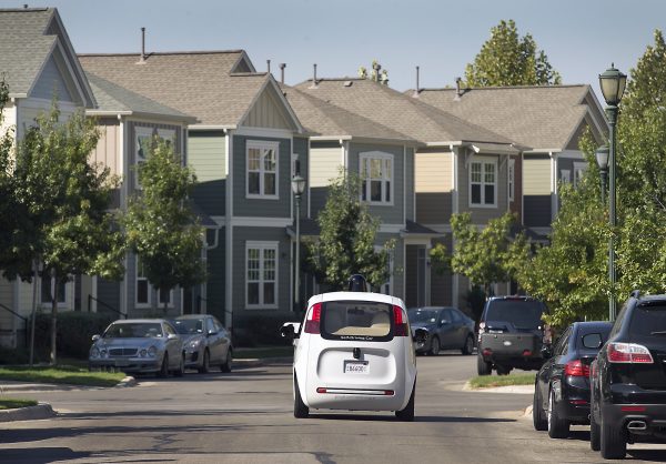 Google's self-driving car tours the Mueller Housing Development in Austin, Texas, on Sept. 23, 2015. Hustling to bring cars that drive themselves to a road near you, Google finds itself somewhere that has frustrated many before: Waiting for help from California's department of motor vehicles. (Ralph Barrera/Austin American-Statesman via AP)