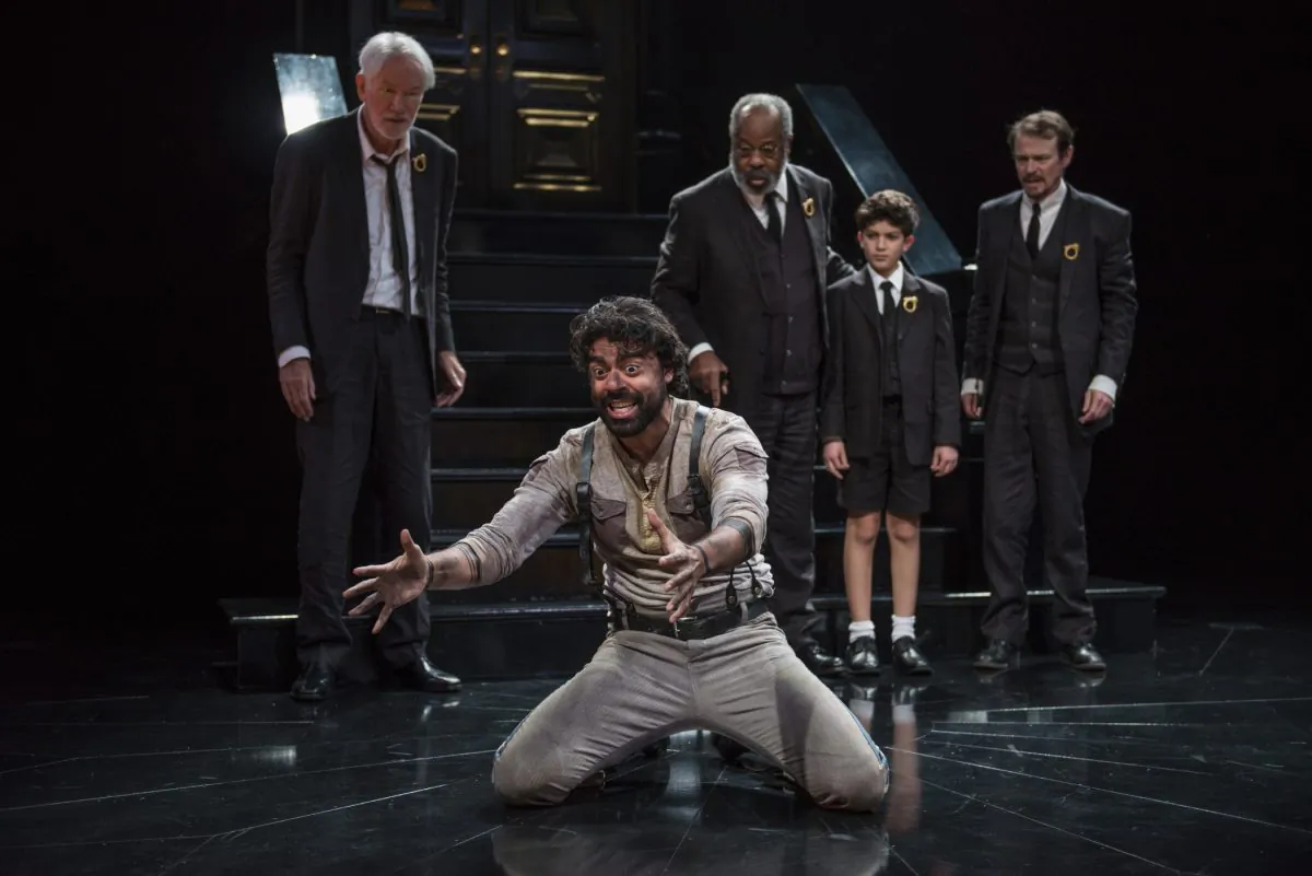 The Herald (Gabriel Ruiz) brings the news of the Greek victory to the people of Argos, (L–R) Gary Wingert, Alfred Wilson, Michael Ghantous, and Thomas Cox in “Agamemnon.” (Michael Brosilow)