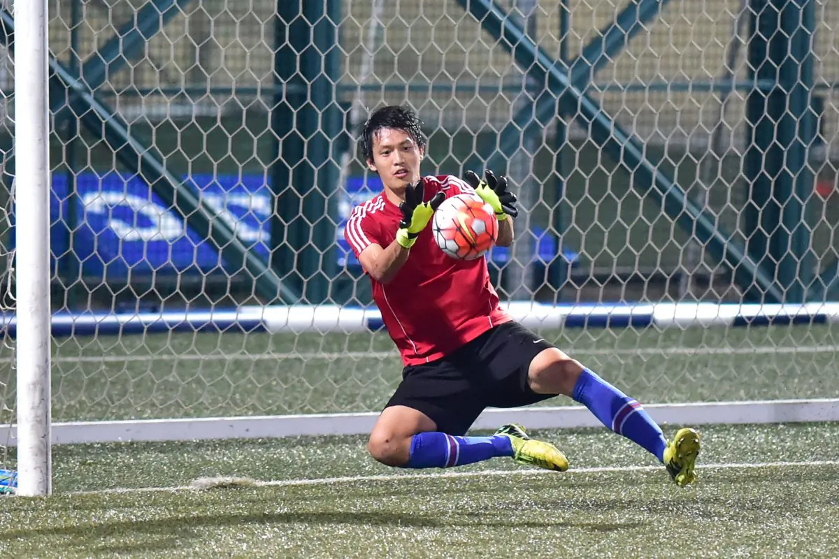 HKU70's goalkeeper saves during their 2-1 defeat by Club Colts in the Yau Yee League first division match at Sports Road on Sunday Nov 15, 2015. (Bill Cox/Epoch Times)