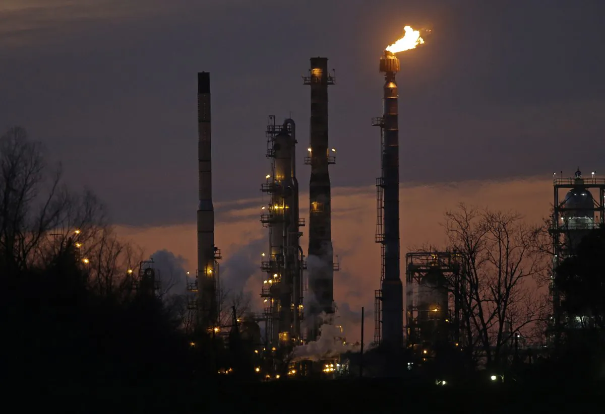 Stacks and burn-off from the ExxonMobil refinery are seen at dusk in St. Bernard Parish, La., on Feb. 13, 2015. (Gerald Herbert/AP Photo)