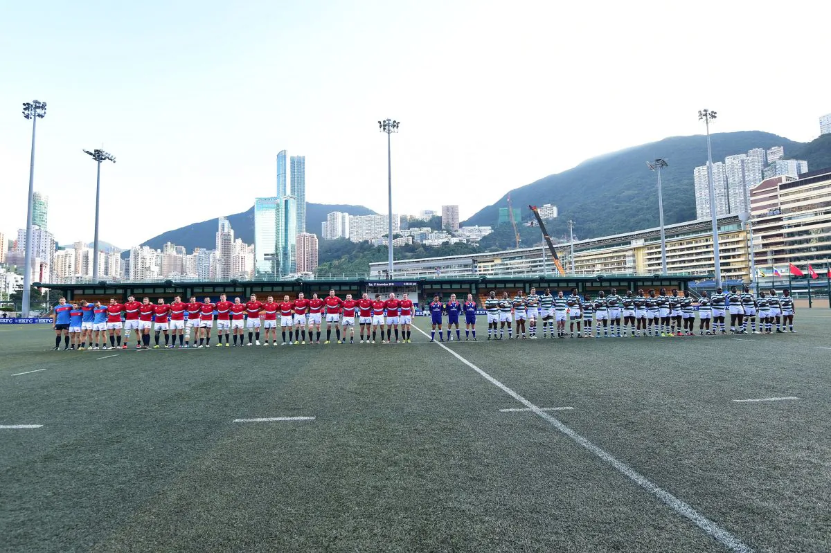 Teams line up before the start of the match between Russia (red) and Zimbabwe (green hoops) in the Cup of Nations in Hong Kong on Tuesday Nov 17, 2015. (Bill Cox/Epoch Times)