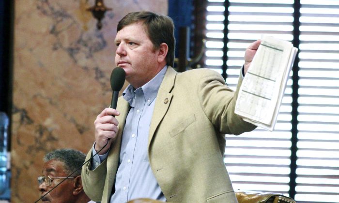 Rep. Bo Eaton II (D-Taylorsville) waves benchmark figures to argue against a proposed Senate redistricting plan in House Chambers at the Capitol in Jackson, Miss., on May 3, 2012. (AP Photo/Rogelio V. Solis)
