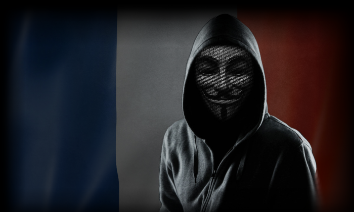 A hooded figure wears a Guy Fawkes mask in an image used by TorReaper, a member of the GhostSec anti-terrorism hacker group. GhostSec and the hacker collective Anonymous are fighting the online presence of ISIS. (GhostSec)