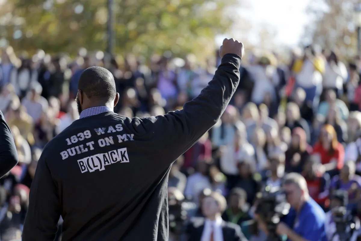 In this Nov. 9, 2015 file photo, a member of the black student protest group Concerned Student 1950 gestures while addressing a crowd following the announcement that University of Missouri System President Tim Wolfe would resign, at the university in Columbia, Mo. (AP Photo/Jeff Roberson)