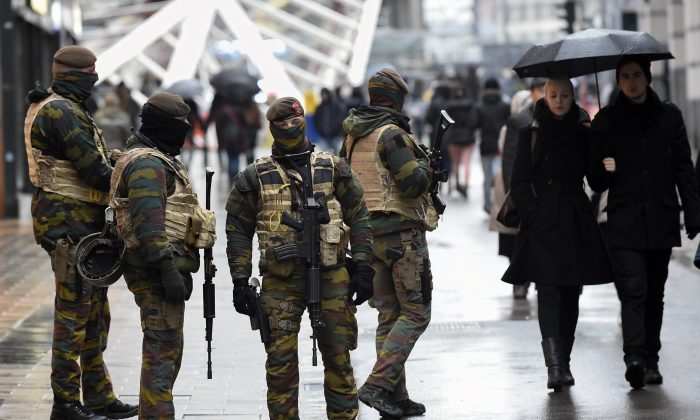 Soldiers patrol the Rue Neuve pedestrian shopping street in Brussels on November 21, 2015. All metro train stations in Brussels will be closed on November 21, the city's public transport network said after Belgium raised the capital's terror alert to the highest level, warning of an "imminent threat." (AFP/Getty Images)