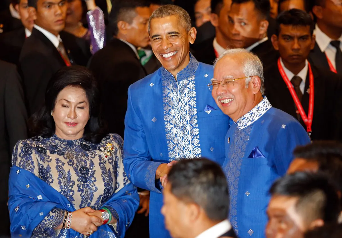President Barack Obama (C), Malaysian Prime Minister Najib Razak (R) and Najib's wife Rosmah Mansor at a Gala Dinner at the Association of Southeast Asian Nations (ASEAN) summit in Kuala Lumpur, Malaysia, Saturday, Nov. 21, 2015. (AP Photo/Lai Seng Sin)