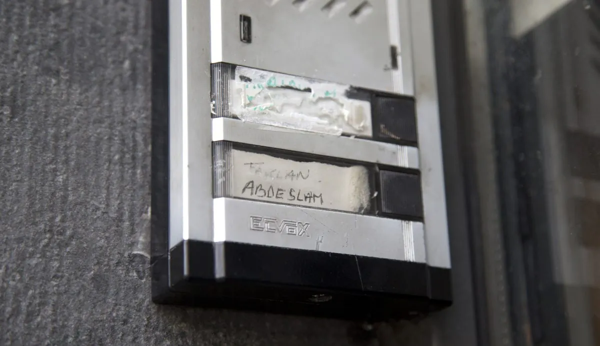 The Abdeslam name is shown on the doorbell on the house of the family of Belgian militants Brahim and Salah Abdeslam in Molenbeek, Belgium, on Nov. 18, 2015. The family homes of the suspected mastermind of the Paris attacks and one of the suicide bombers stand only a few blocks apart in the Belgian capital's Molenbeek neighborhood. (AP Photo/Virginia Mayo)