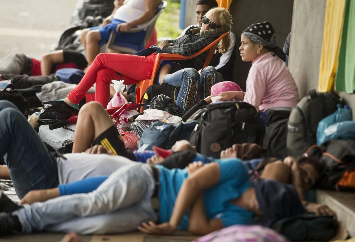Cuban migrants rest outside the Costa Rican immigration building at the border with Nicaragua, in Penas Blancas, Costa Rica, on Nov. 16, 2015. A surge of some 2,000 Cuban migrants trying to cross Central America to reach the United States triggered a diplomatic spat between Costa Rica and Nicaragua Monday, plunging tense relations between the two countries to a new low. (AP Photo/Esteban Felix)