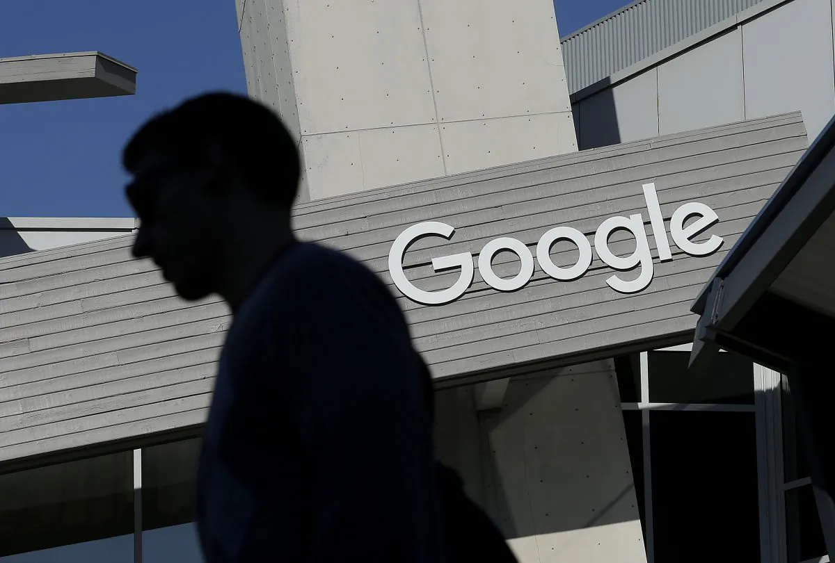 A man walks past a building on the Google campus in Mountain View, Calif., on Nov. 12, 2015. (AP Photo/Jeff Chiu)