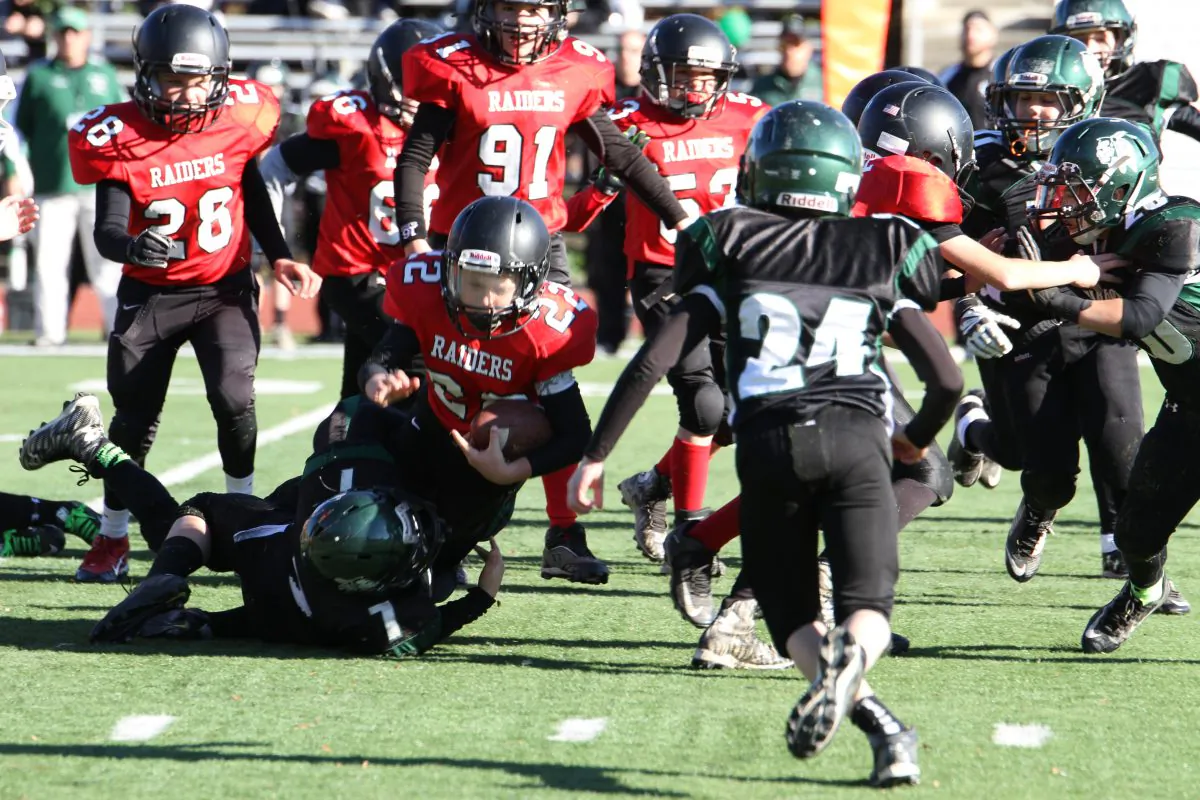 Jared Demarco, number 22 with the  Port Jervis Raiders, runs with the ball for a first down during the division II Orange County Youth Football League Superbowl in Newburgh on Nov. 21, 2015. (Rob Waligroski)