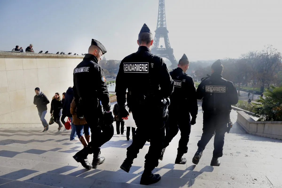 French gendarmes officers patrol near the Eiffel Tower, in Paris, Monday Nov. 23, 2015.  French President Francois Hollande will preside over a national ceremony on Nov. 27 honoring the at least 130 victims of the deadliest attacks on France in decades.  (AP Photo/Jacques Brinon)