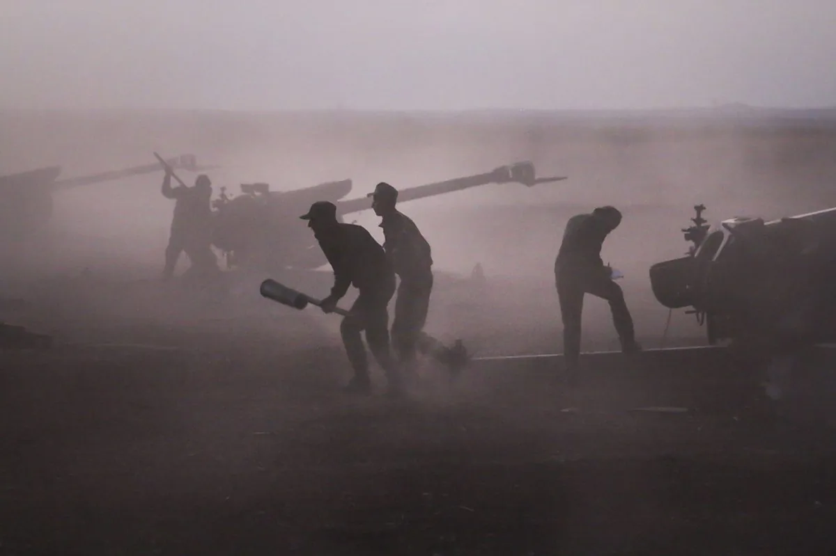 Syrian army personnel load howitzers near the village of Morek, Syria, on Oct. 7, 2015. (Alexander Kots/Komsomolskaya Pravda via AP)