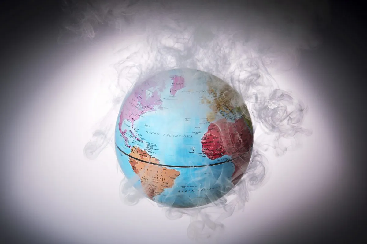 A picture taken on Nov. 10, 2015 shows a small globe surrounded by smoke to illustrate global warming. (Lionel Bonaventure/AFP/Getty Images)