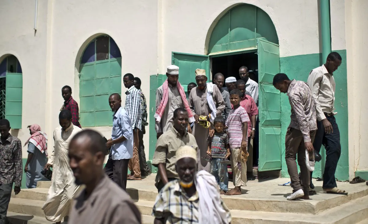 In this photo taken Monday, Nov. 9, 2015, Kenyan Muslim men leave after making afternoon prayers at the Ibnu-qeym Mosque in Garissa, Kenya. (AP Photo/Ben Curtis)