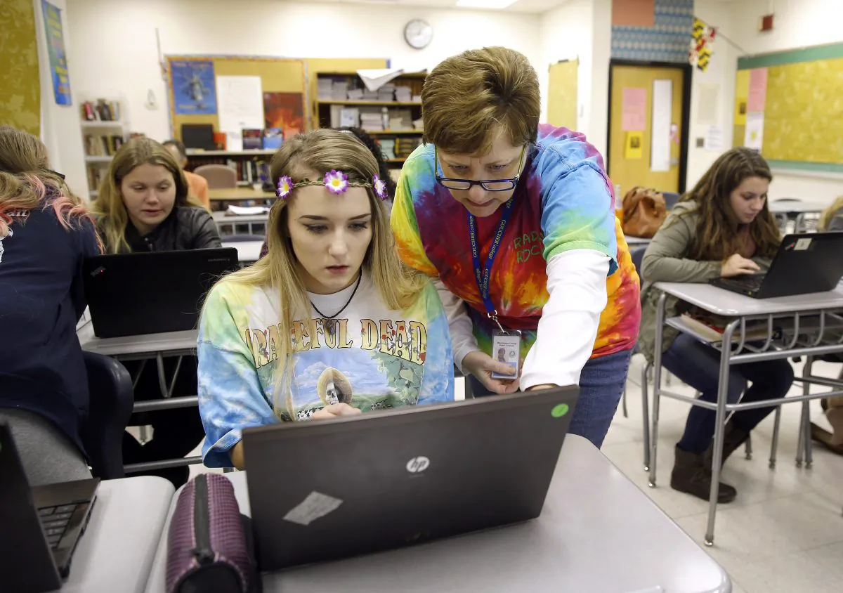 A file photo shows a teacher instructing a student on a laptop as they prepare for a special project in Hagerstown, Md., on Nov. 12, 2015. (Patrick Semansky/AP Photo)