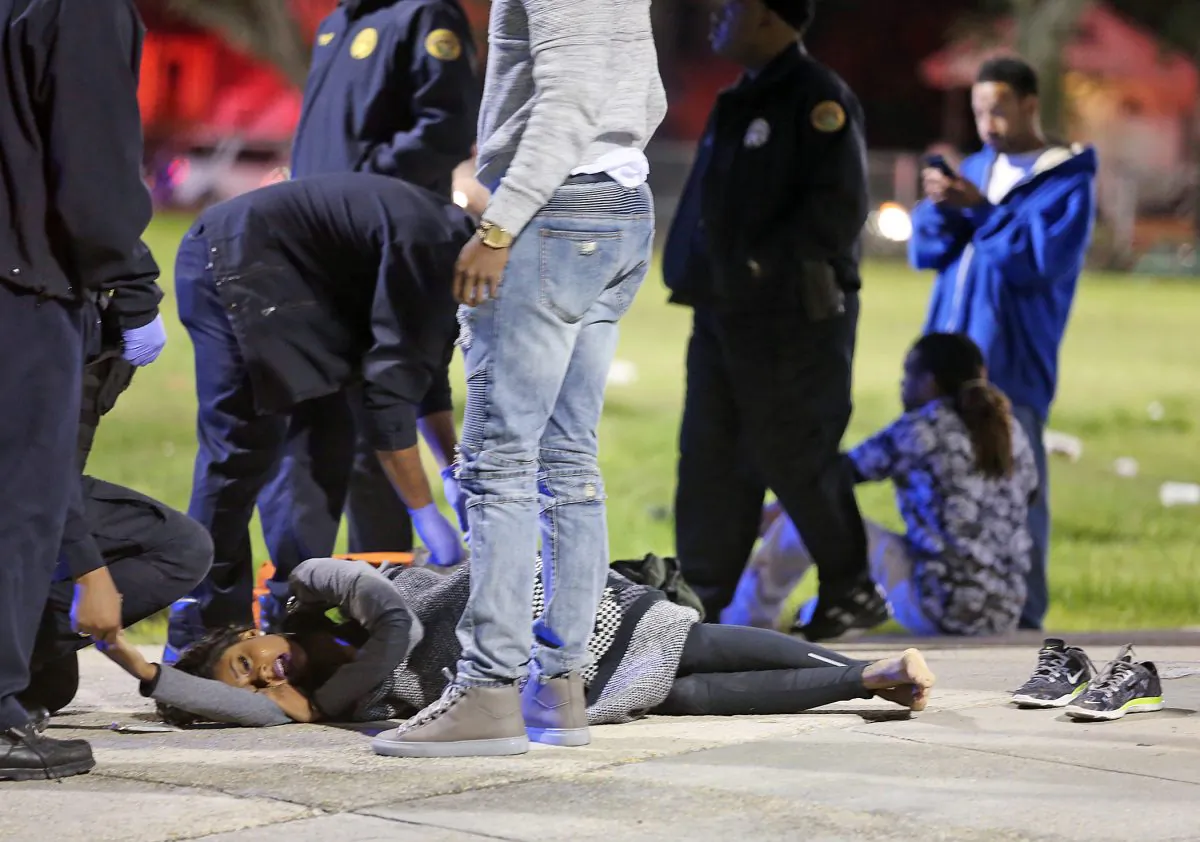 People await transport to a hospital after a shooting in New Orleans' 9th Ward on Sunday, Nov. 22, 2015. (Michael DeMocker/NOLA.com The Times-Picayune via AP)