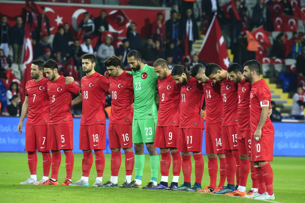 Turkey's players observe a minute of silence to honour the victims of the Paris attacks prior to an international friendly soccer match against Greece, in Istanbul, Tuesday Nov. 17, 2015. (AP Photo/Lefteris Pitarakis)