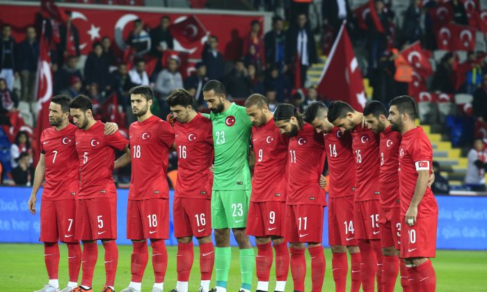 Turkey's players observe a minute of silence to honour the victims of the Paris attacks prior to an international friendly soccer match against Greece, in Istanbul, Tuesday Nov. 17, 2015. (AP Photo/Lefteris Pitarakis)