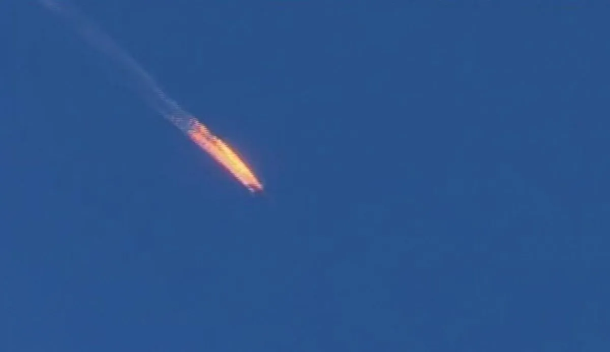 This frame grab from video by Haberturk TV, shows a Russian warplane on fire before crashing on a hill as seen from Hatay province, Turkey, Tuesday, Nov. 24, 2015. (Haberturk TV via AP)