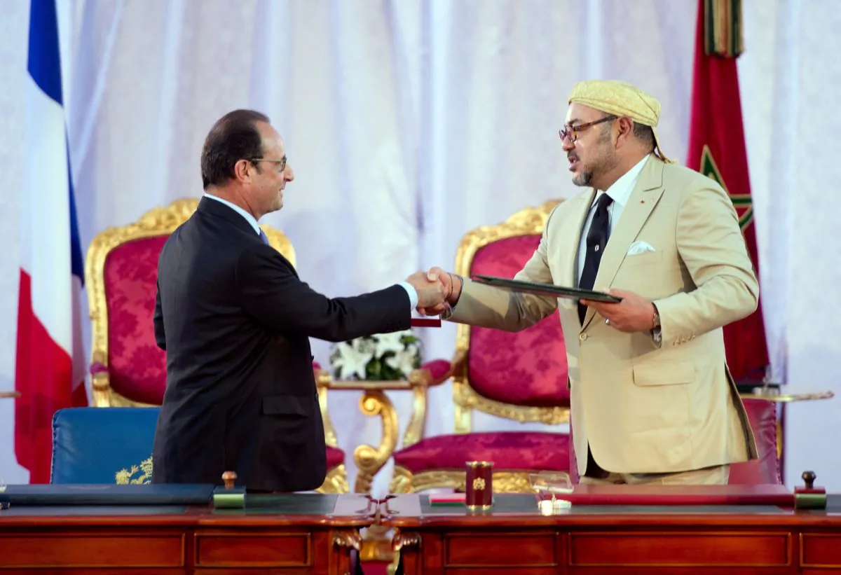 French President Francois Hollande (L) and Morocco's King Mohammed VI shake hands after signing an agreement on Sept. 20, 2015, during a meeting in the Moroccan port city of Tangier. (Alain Jocard/AFP/Getty Images)