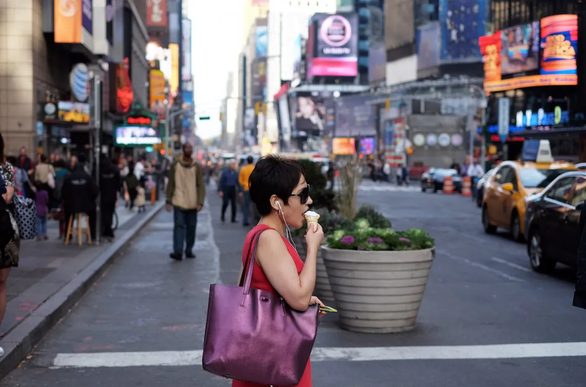 A woman has an ice-cream on a cone as she walks along a street in New York on November 6, 2015. (JEWEL SAMAD/AFP/Getty Images)