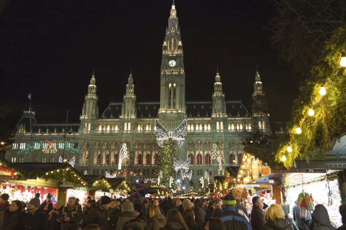Shoppers check out the decorated stalls for sweets, baking, and handcrafted gifts at the Christmas market in front of Vienna’s city hall. (tgasser/iStock)