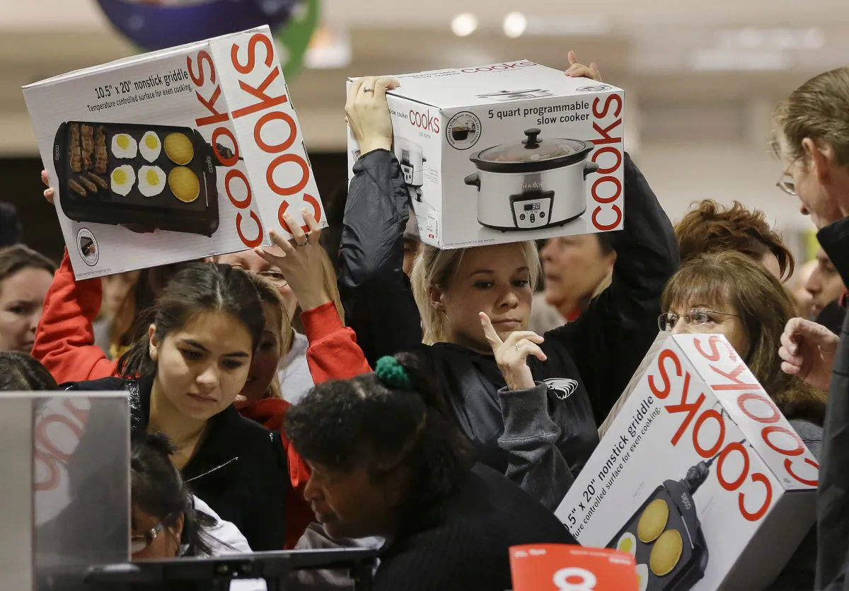 Shoppers rush to grab electric griddles and slow cookers on sale for $8 shortly after the doors opened at a J.C. Penney on the morning of the black Friday in 2012 in Las Vegas.  (AP Photo/Julie Jacobson)