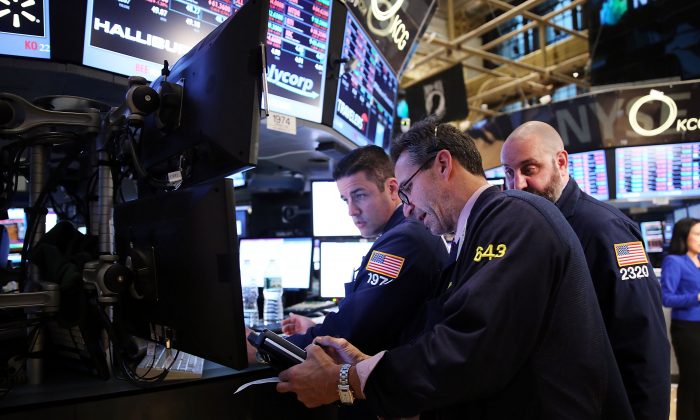 Traders work on the floor of the New York Stock Exchange at the end of the trading day in New York City on Feb. 3, 2014. The global economy is facing new threats it is unable to defend against. (Spencer Platt/Getty Images)