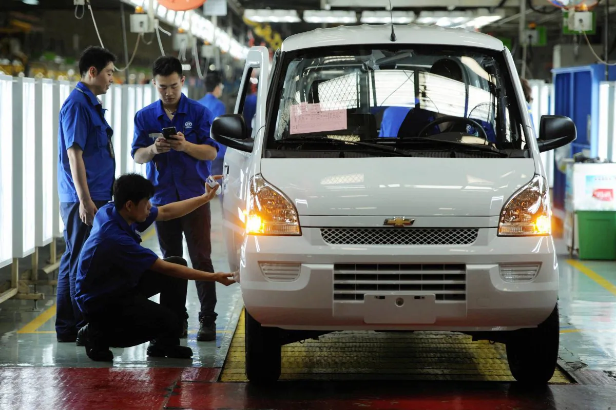 Workers install car parts at a factory in Qingdao, Shandong Province, China, on July 15, 2015. Businesses are struggling to compete with low quality, low cost Chinese products. (STR/AFP/Getty Images)